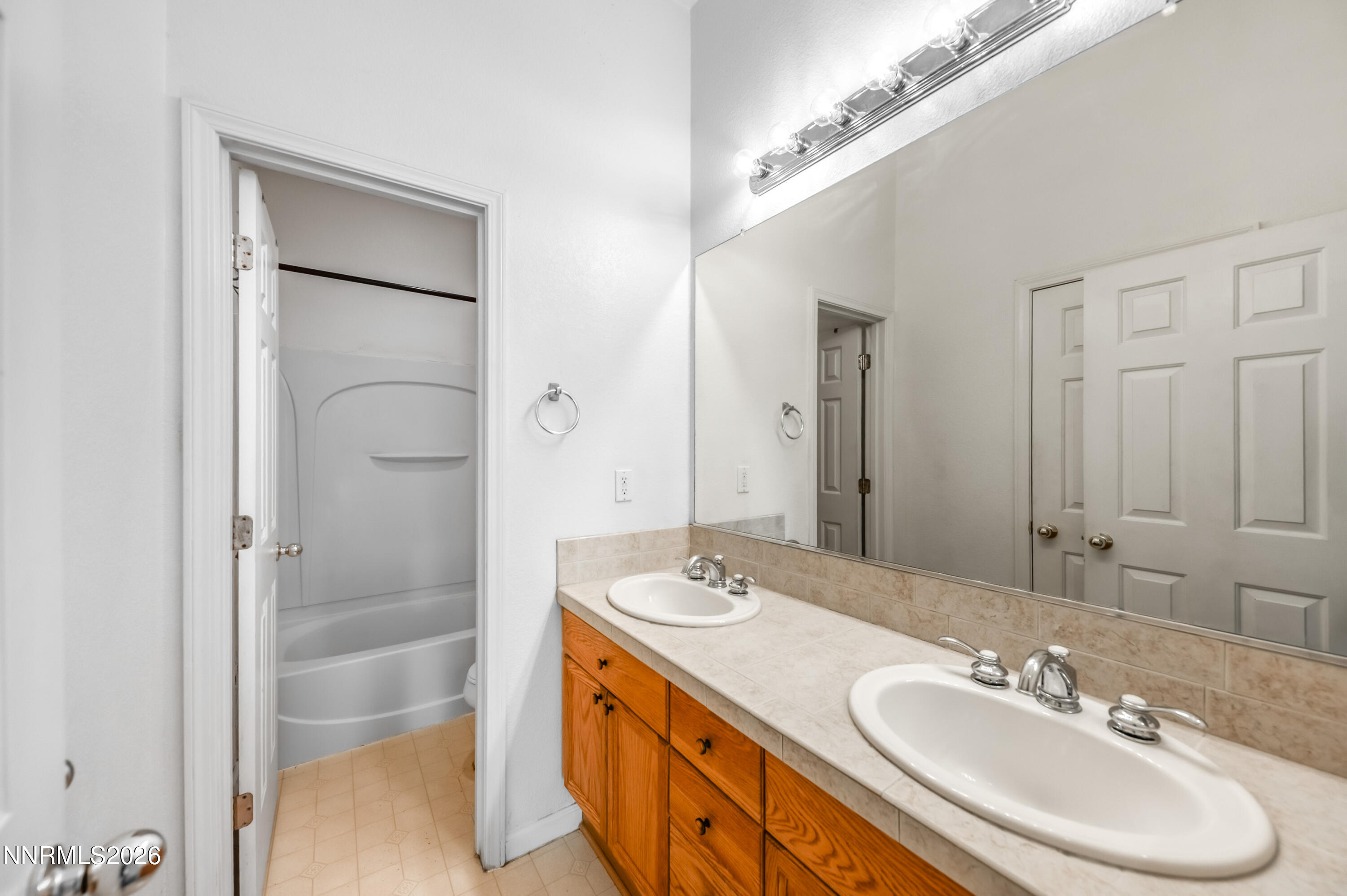 10145 Lucente Way Reno, NV 89521 - Photo 33 of 54 a bathroom with a double vanity sink and a mirror