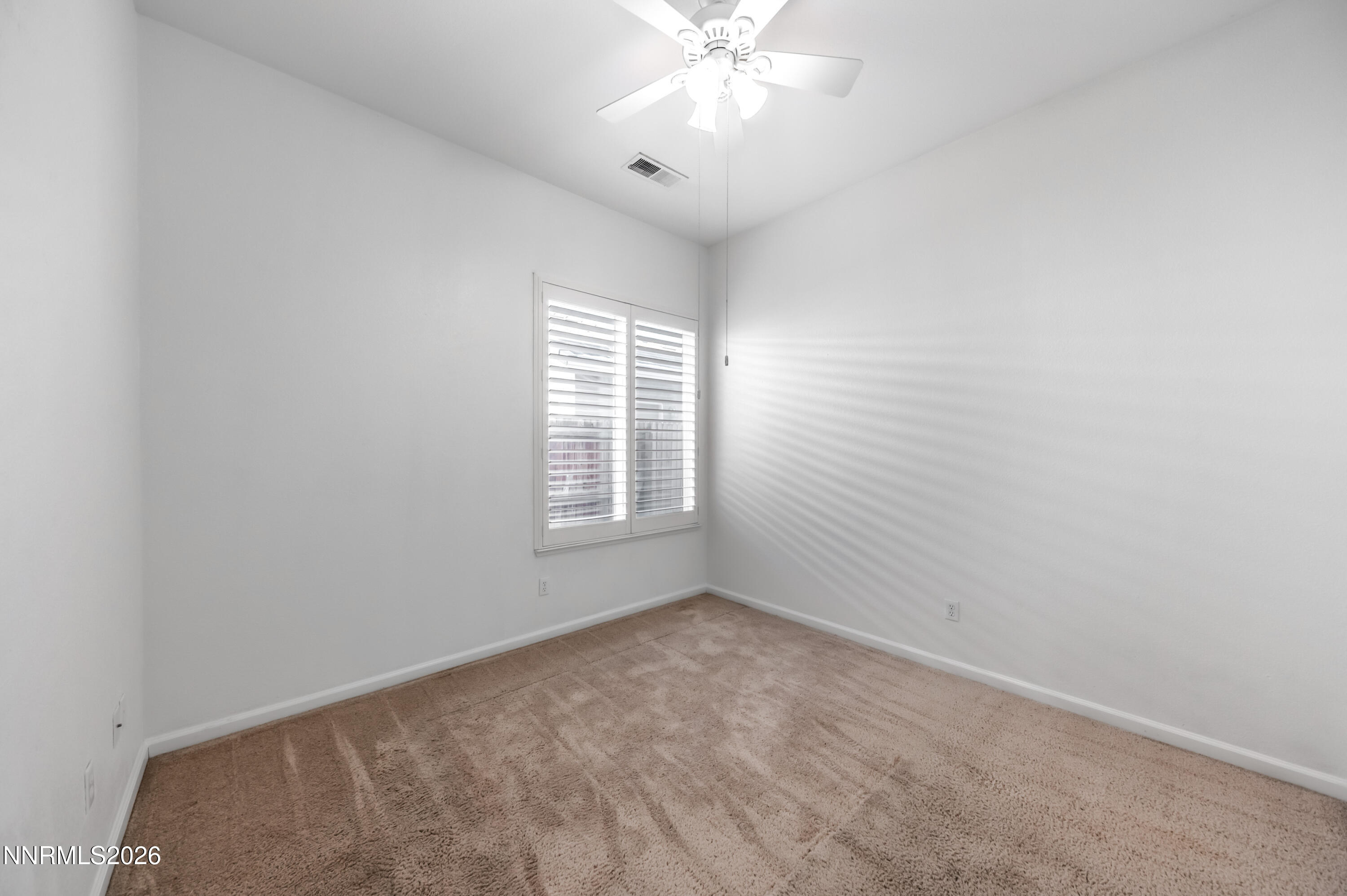 10145 Lucente Way Reno, NV 89521 - Photo 35 of 54 a view of an empty room with a window