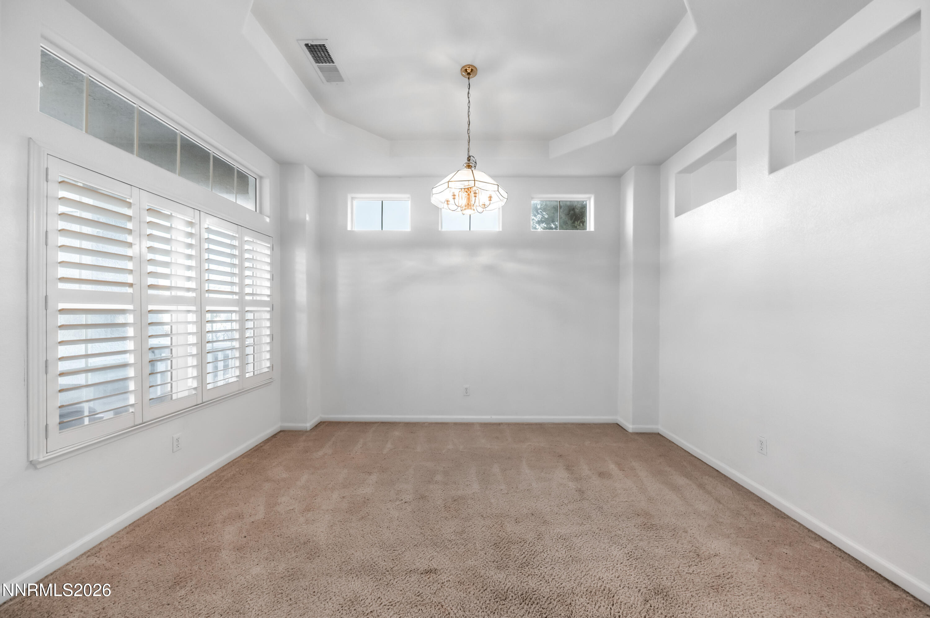 10145 Lucente Way Reno, NV 89521 - Photo 9 of 54 a view of a room with windows and chandelier
