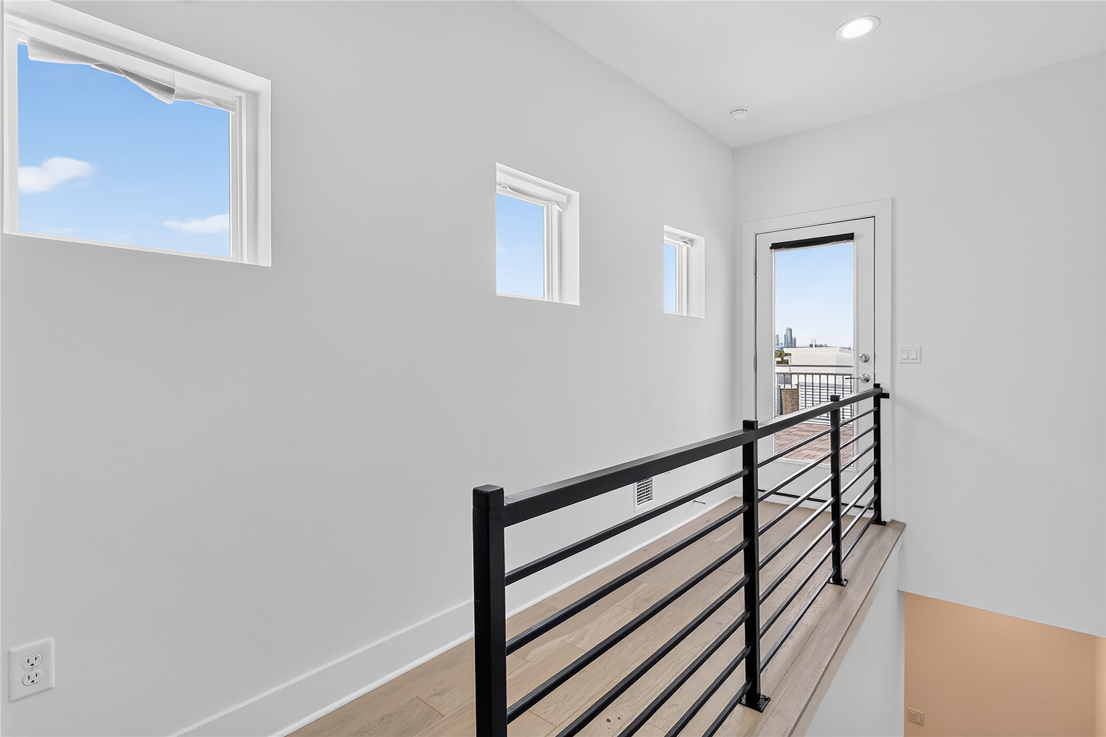 2805 McCurdy Street, Unit 14 Austin, TX 78723 - Photo 25 of 40 A well-lit upper landing connects to an outdoor balcony with city views.