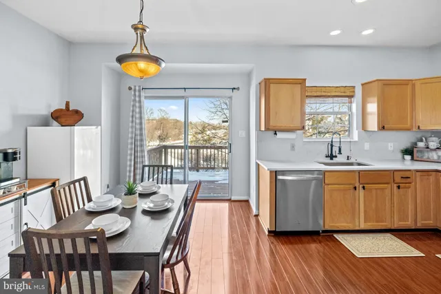 a view of a kitchen area with furniture and wooden floor