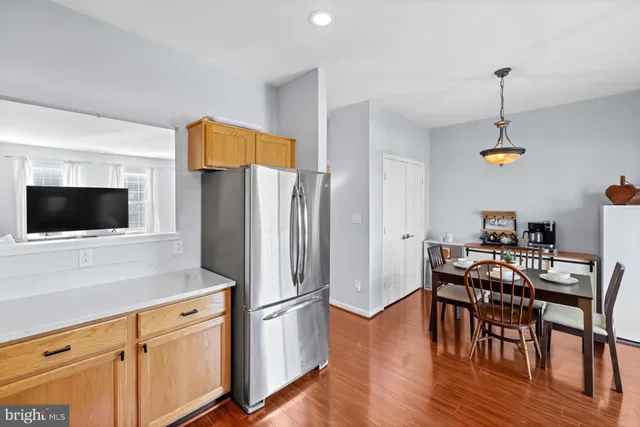 a view of a kitchen with a table and chairs