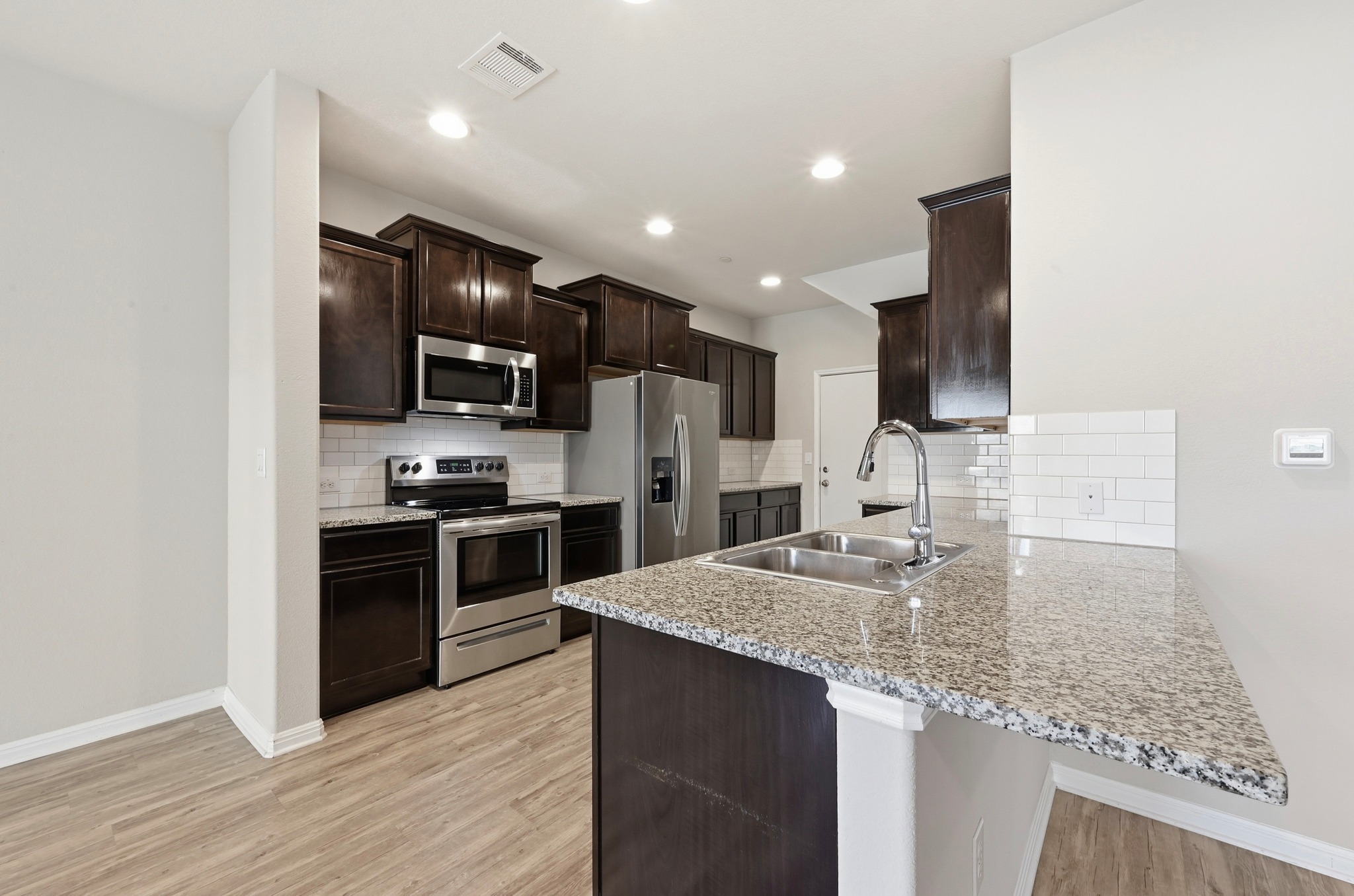 516 East Slaughter Lane, Unit 603 Austin, TX 78744 - Photo 10 of 26 a kitchen with stainless steel appliances granite countertop a sink stove and refrigerator