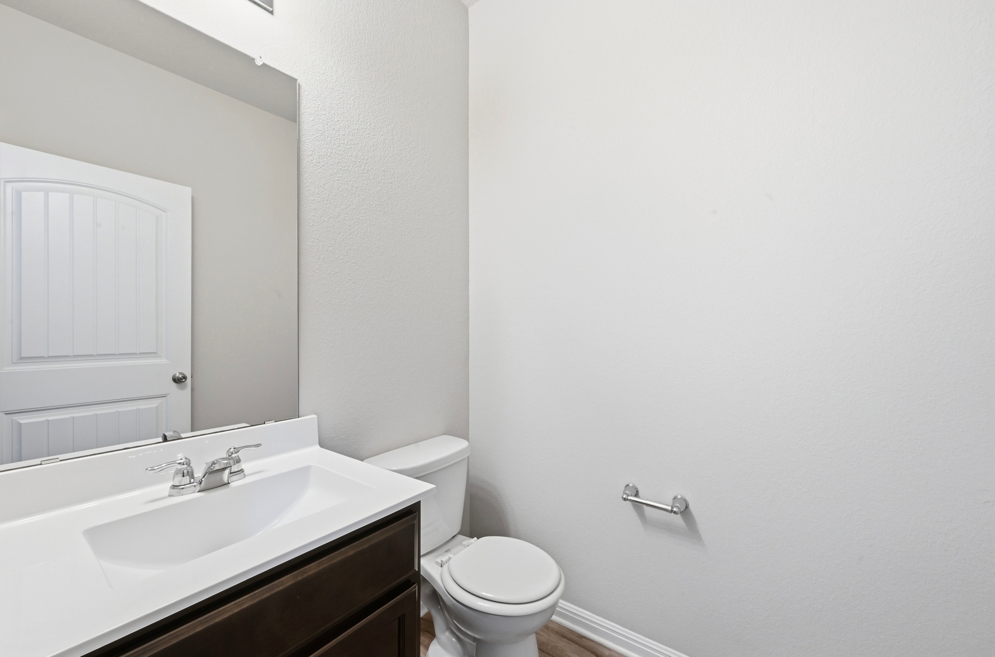 516 East Slaughter Lane, Unit 603 Austin, TX 78744 - Photo 13 of 26 a bathroom with a sink a toilet a mirror and vanity