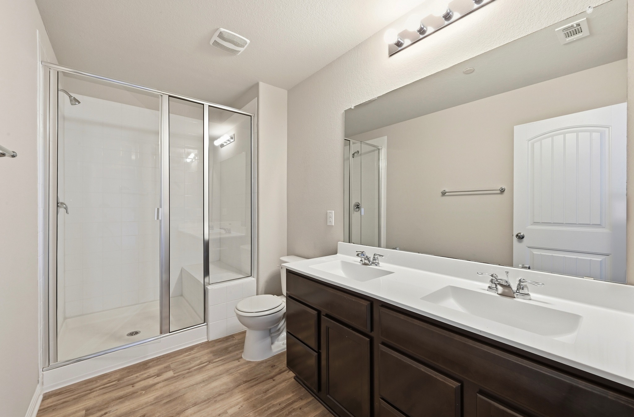 516 East Slaughter Lane, Unit 603 Austin, TX 78744 - Photo 16 of 26 a bathroom with a double vanity sink toilet and shower