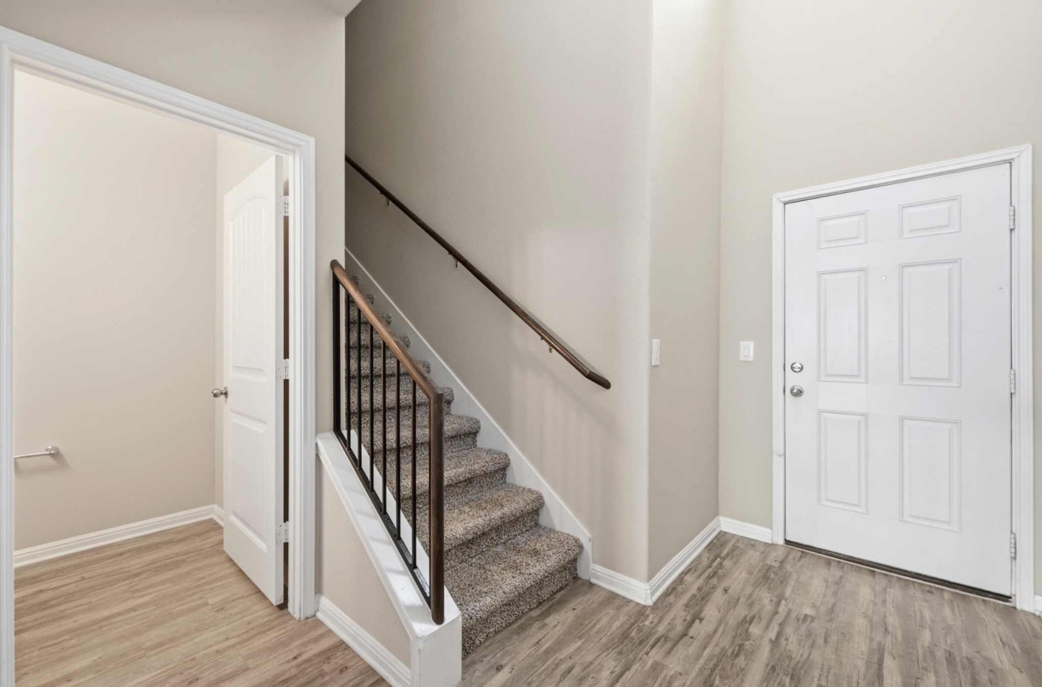516 East Slaughter Lane, Unit 603 Austin, TX 78744 - Photo 4 of 26 a view of a hallway with wooden floor and staircase