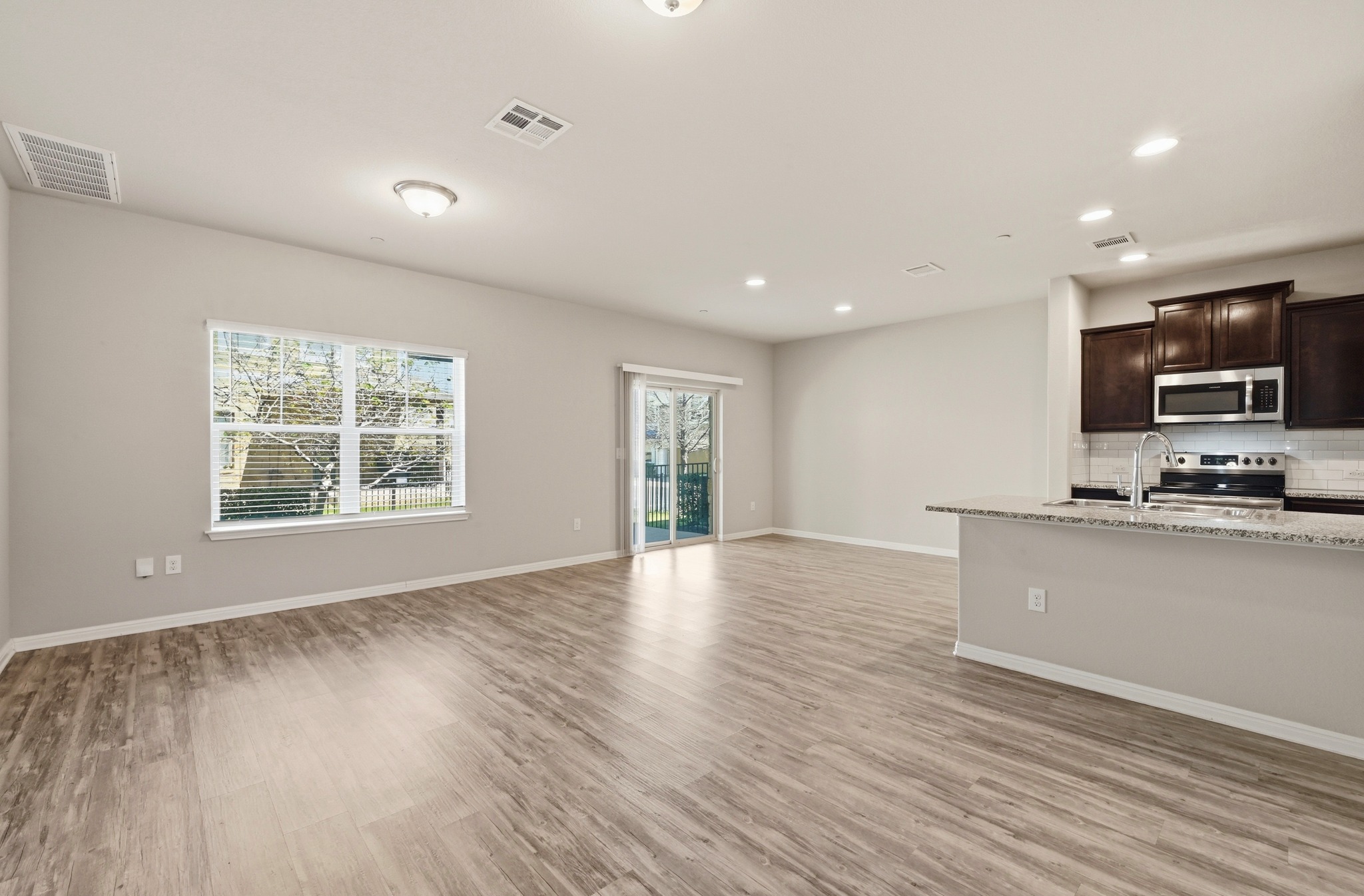 516 East Slaughter Lane, Unit 603 Austin, TX 78744 - Photo 5 of 26 a view of kitchen with wooden floor and window