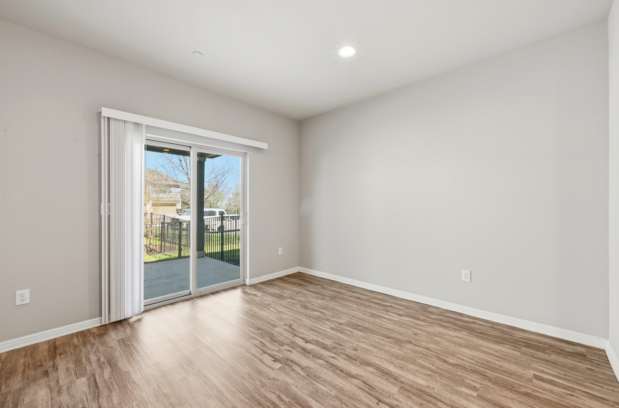 516 East Slaughter Lane, Unit 603 Austin, TX 78744 - Photo 9 of 26 a view of an empty room with wooden floor and a window