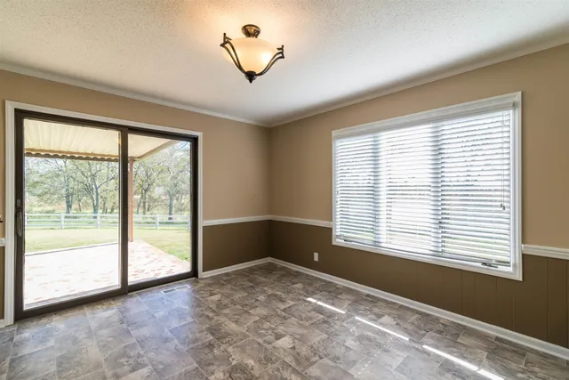 a bathroom with a granite countertop sink a toilet and shower