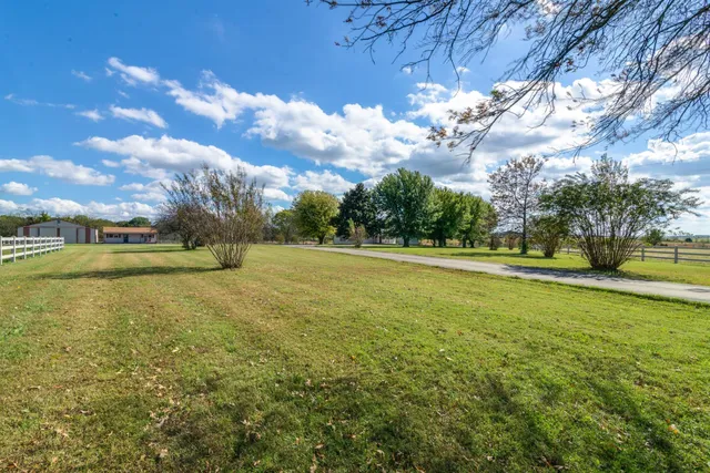 a view of a swimming pool and chairs in patio