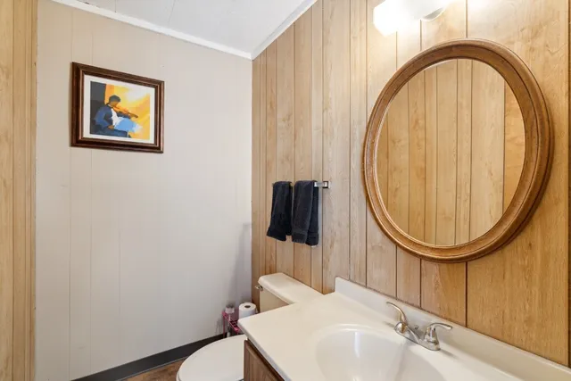 a kitchen with stainless steel appliances granite countertop a table chairs and a refrigerator