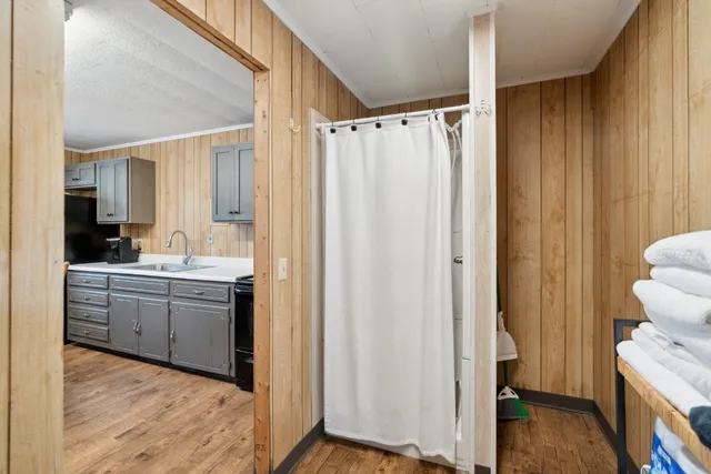 a kitchen with stainless steel appliances a refrigerator a stove a dining table and chairs