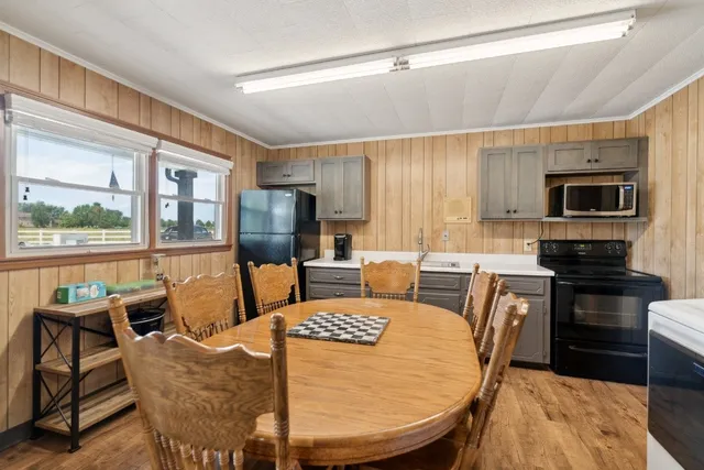 a view of a dining room with furniture and a chandelier