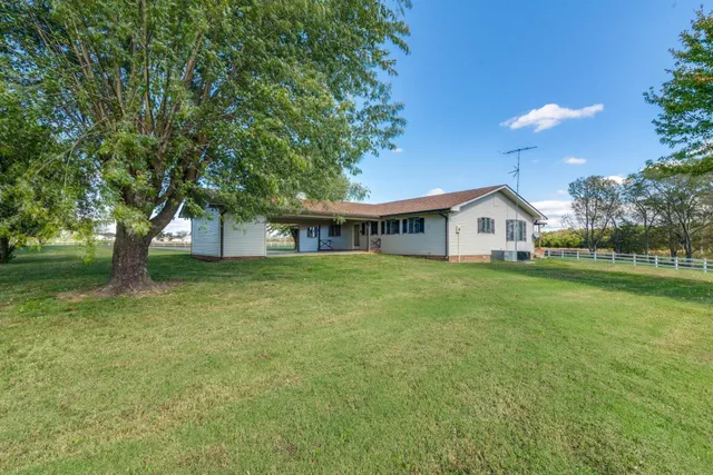 a room with stainless steel appliances kitchen island granite countertop furniture and a kitchen view