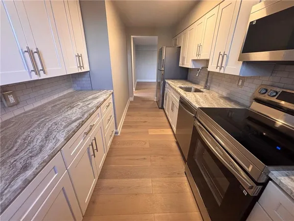 a view of a kitchen with sink and dishwasher