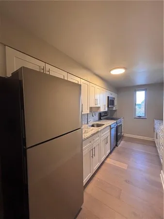 a kitchen with stainless steel appliances a refrigerator and a sink