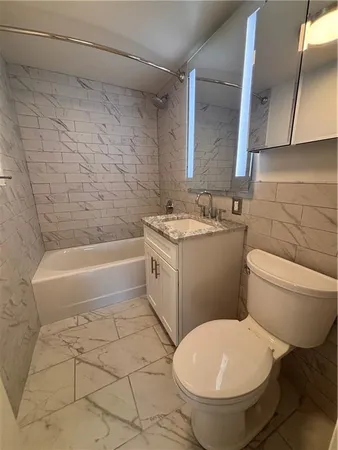 a bathroom with a toilet a sink and bathtub