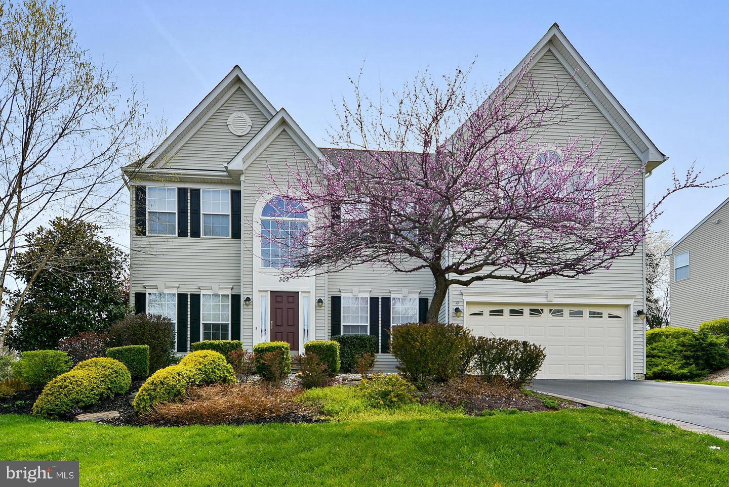 302 Riding Trail Court Northwest Leesburg, VA 20176 - Photo 1 of 15 a front view of a house with a yard and garage