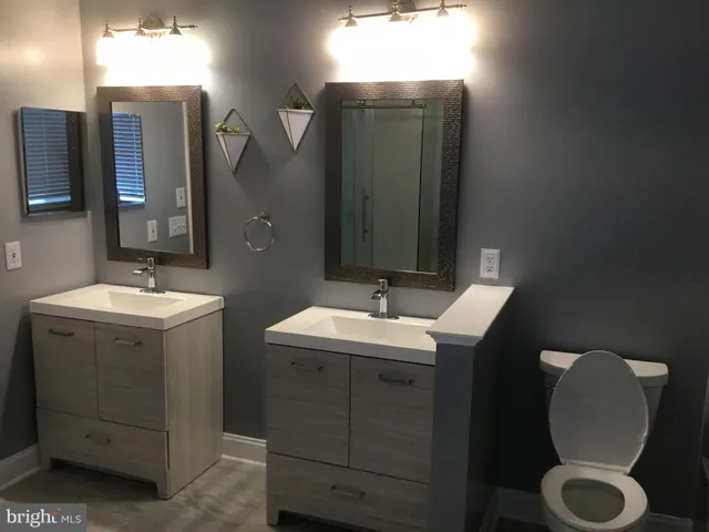 a bathroom with a double vanity sink and mirror