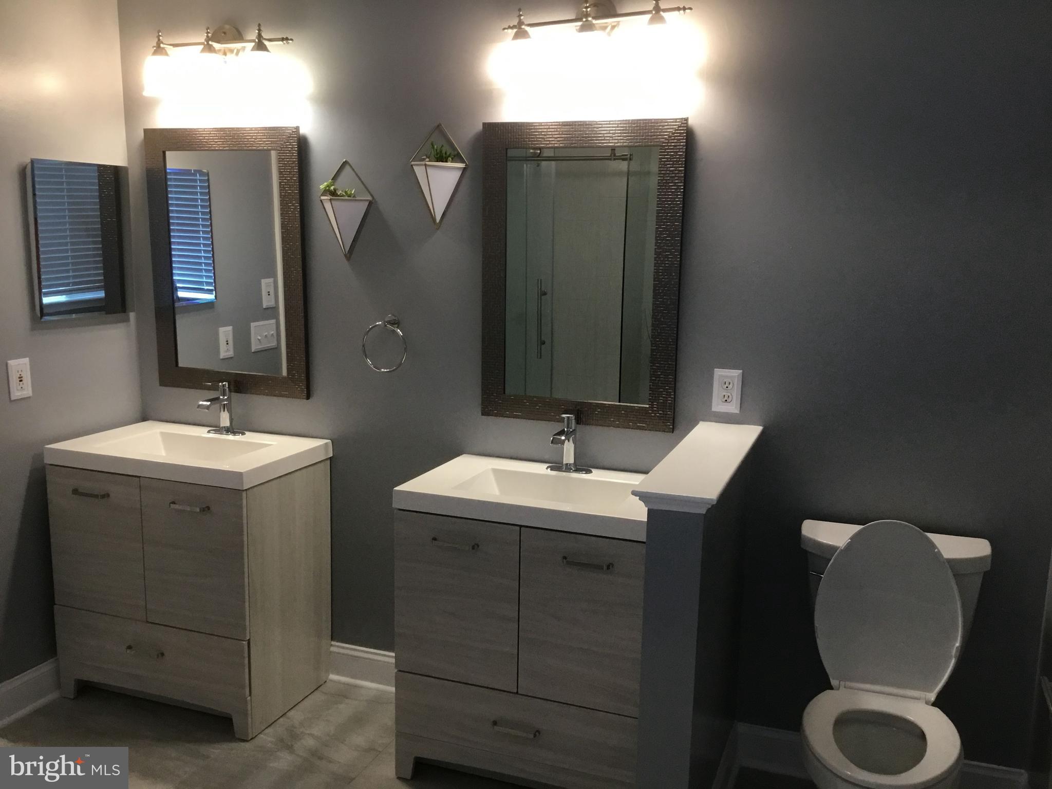 302 Riding Trail Court Northwest Leesburg, VA 20176 - Photo 12 of 15 a bathroom with a double vanity sink and mirror