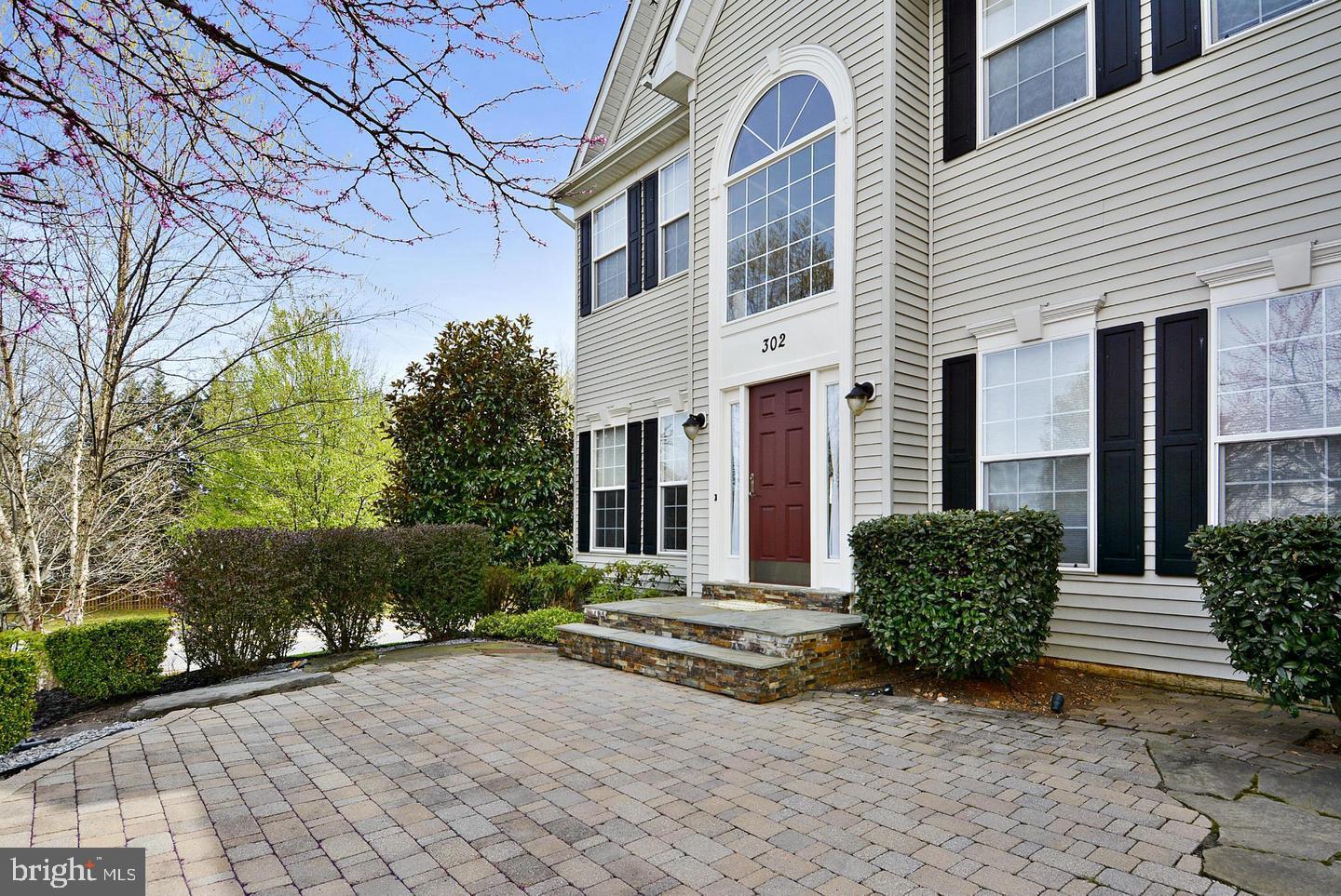 302 Riding Trail Court Northwest Leesburg, VA 20176 - Photo 2 of 15 a front view of a house with garden