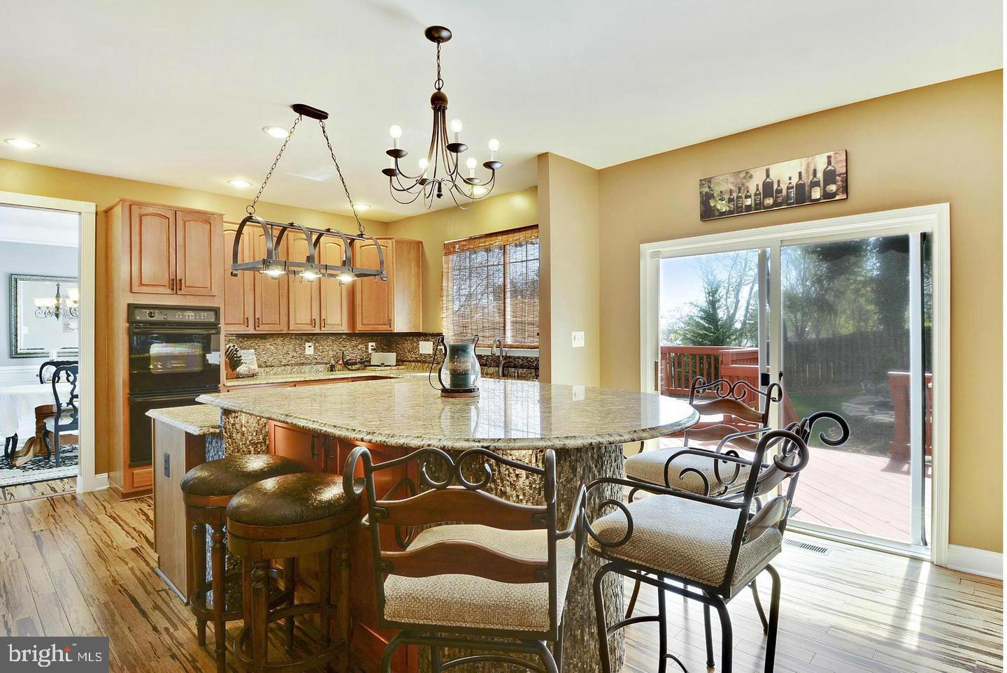 302 Riding Trail Court Northwest Leesburg, VA 20176 - Photo 6 of 15 a view of a dining room and livingroom with furniture wooden floor a chandelier