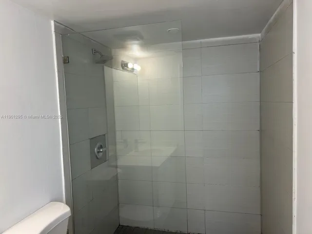 a bathroom with a shower and toilet
