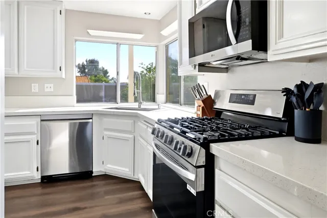 a kitchen with granite countertop a stove and a sink