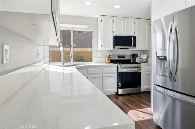 a large kitchen with a stove and a refrigerator