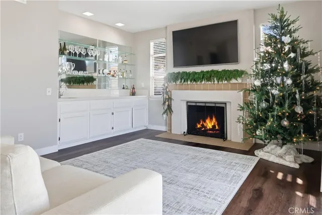 a living room with a fireplace and a flat screen tv