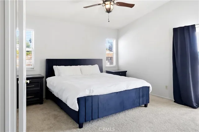 a bedroom with a bed lamp and window