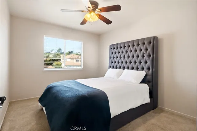 a bedroom with a bed and a painting on the wall