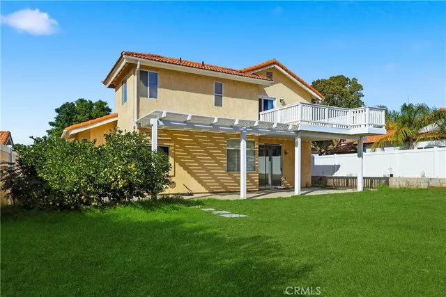 a view of a house with a yard and sitting area