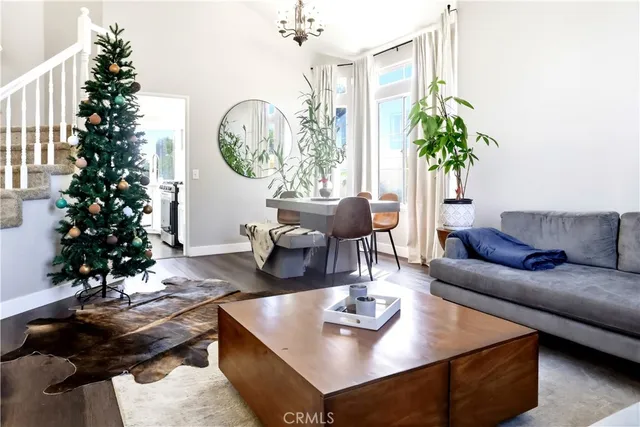 a living room with furniture a clock and a large window