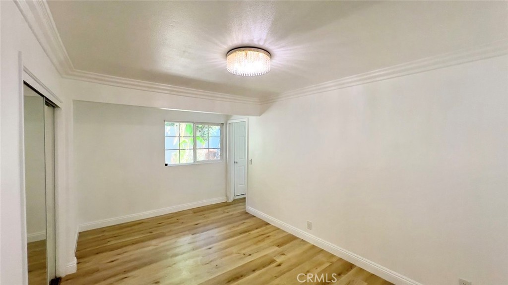 900 South Hayward Street Anaheim, CA 92804 - Photo 11 of 38 a view of room with wooden floor and fan