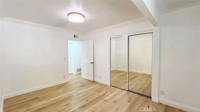 a view of a room with wooden floor and bathroom
