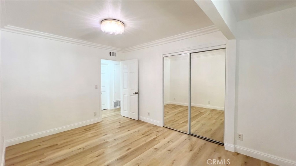 900 South Hayward Street Anaheim, CA 92804 - Photo 12 of 38 a view of a room with wooden floor and bathroom