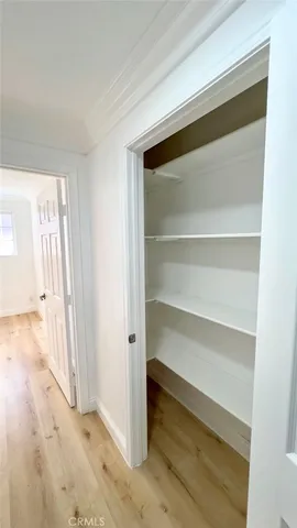a view of a room with wooden floor and closet