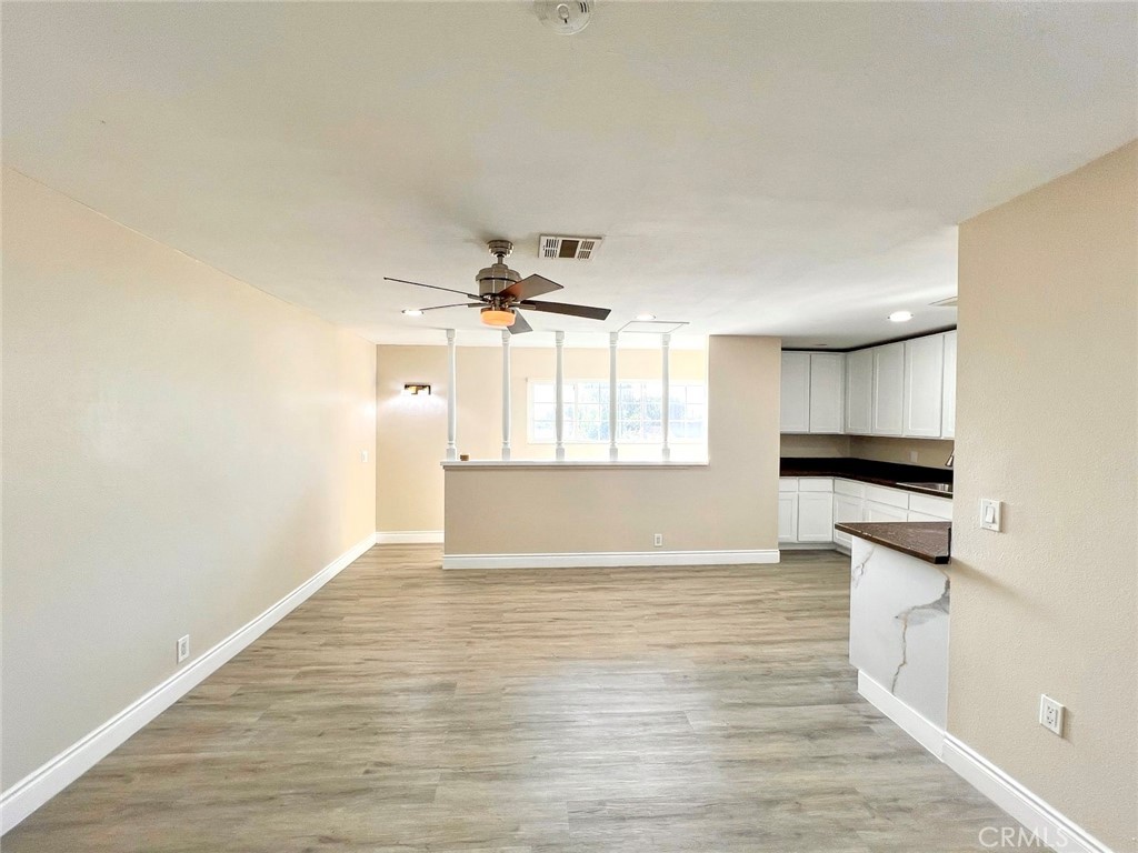 900 South Hayward Street Anaheim, CA 92804 - Photo 31 of 38 a view of empty room with wooden floor and window