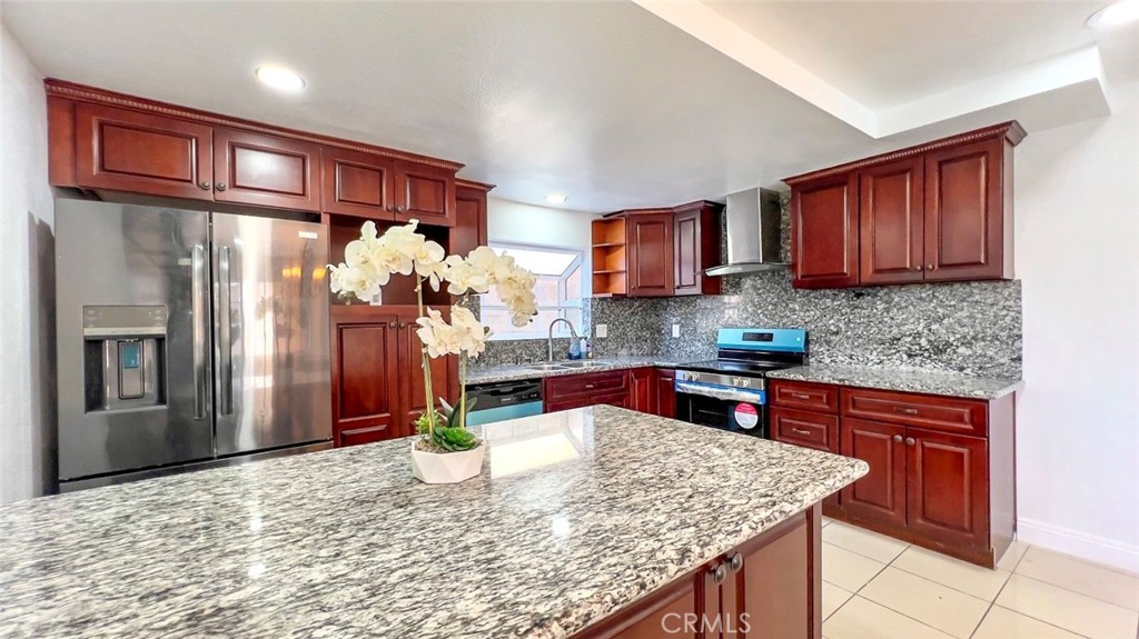 900 South Hayward Street Anaheim, CA 92804 - Photo 6 of 38 a kitchen with stainless steel appliances granite countertop a refrigerator sink and cabinets