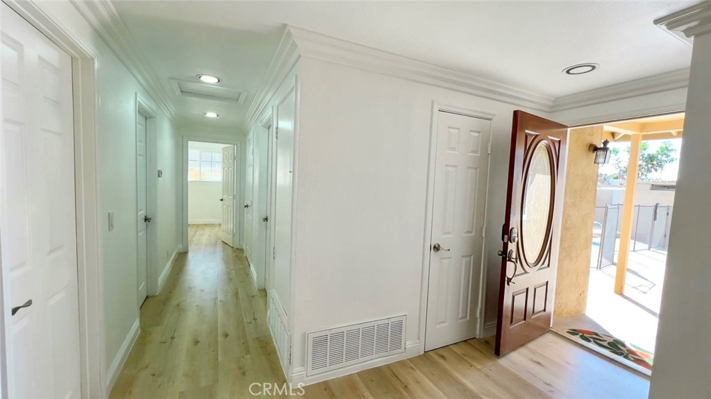 900 South Hayward Street Anaheim, CA 92804 - Photo 7 of 38 a view of a hallway with wooden floor and glass door
