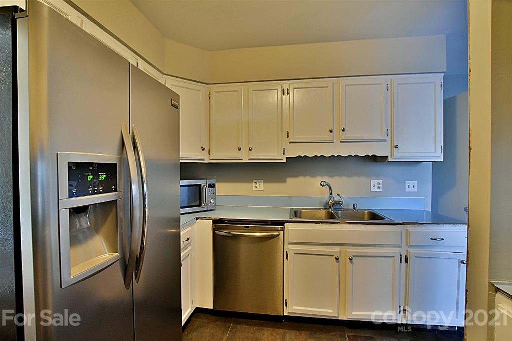 4078 Point Clear Drive Tega Cay, SC 29708 - Photo 14 of 28 a kitchen with stainless steel appliances granite countertop a refrigerator sink and cabinets