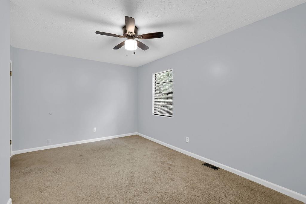 1424 Springleaf Circle Southeast Smyrna, GA 30080 - Photo 31 of 38 an empty room with a window and a fan