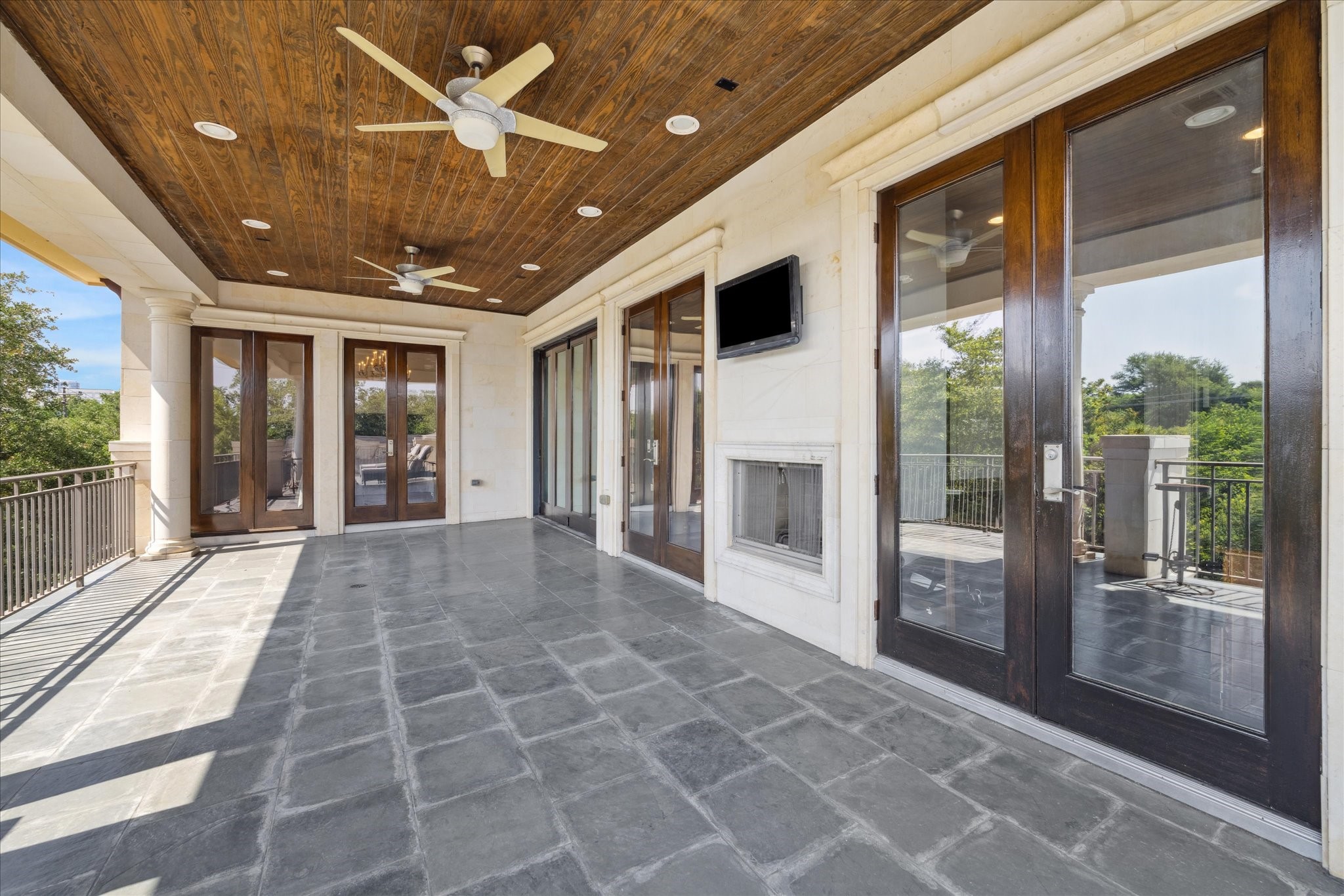 2247 Bartlett Street Houston, TX 77098 - Photo 46 of 50 The large 1000sqft covered, side third floor TERRACE with fireplace overlooking the treeptops of the Museum District is a wonderful entertaining area.