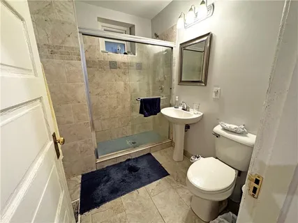 a bathroom with a sink toilet and shower