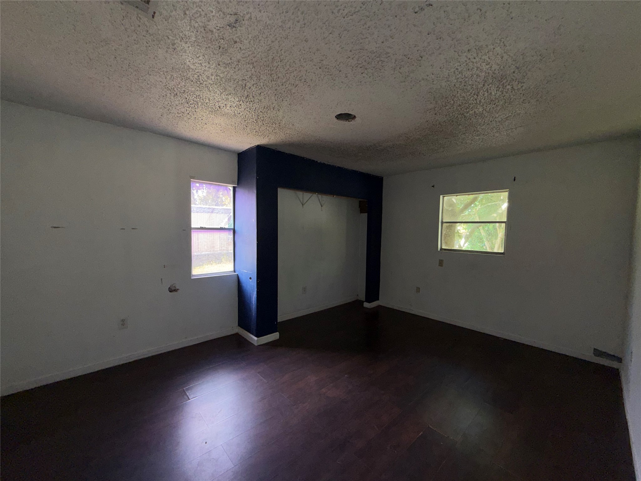 735 Pecan Street Fresno, TX 77545 - Photo 6 of 7 an empty room with wooden floor and windows