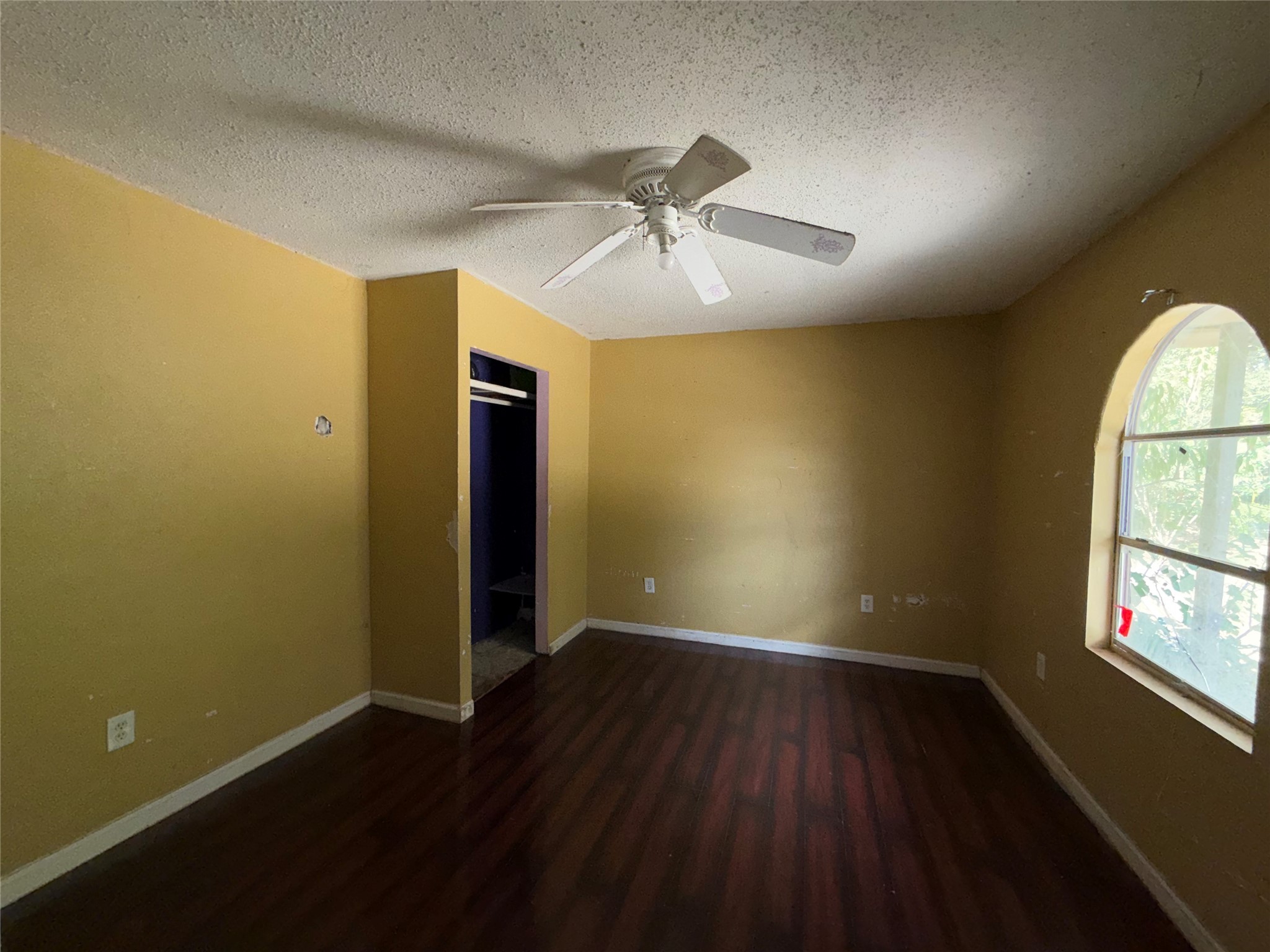 735 Pecan Street Fresno, TX 77545 - Photo 7 of 7 an empty room with wooden floor chandelier fan and windows