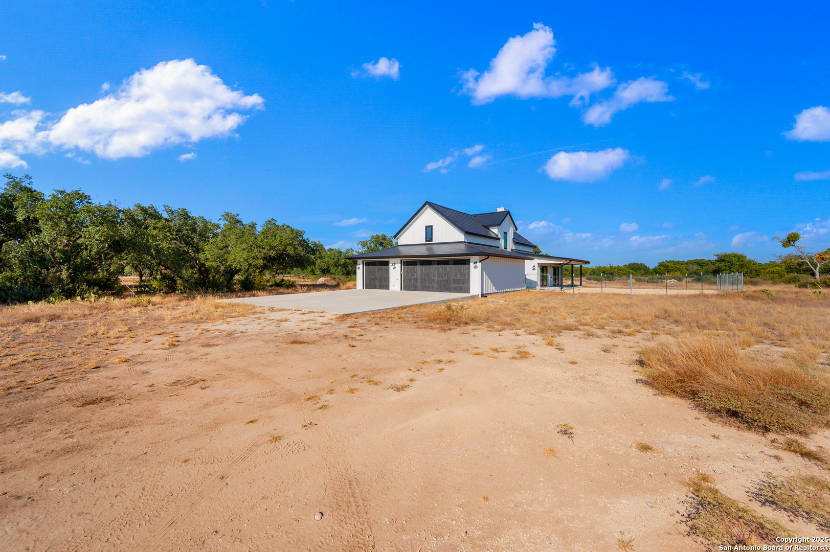 235 Sattler Road Spring Branch, TX 78070 - Photo 26 of 43 a view of white house with a yard