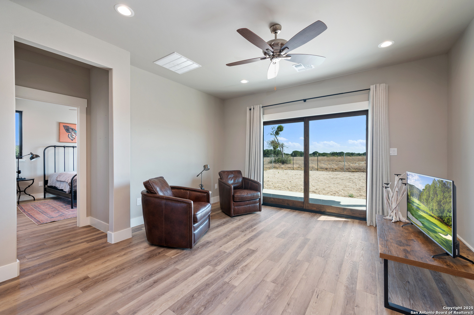 235 Sattler Road Spring Branch, TX 78070 - Photo 28 of 43 a living room with furniture and a flat screen tv