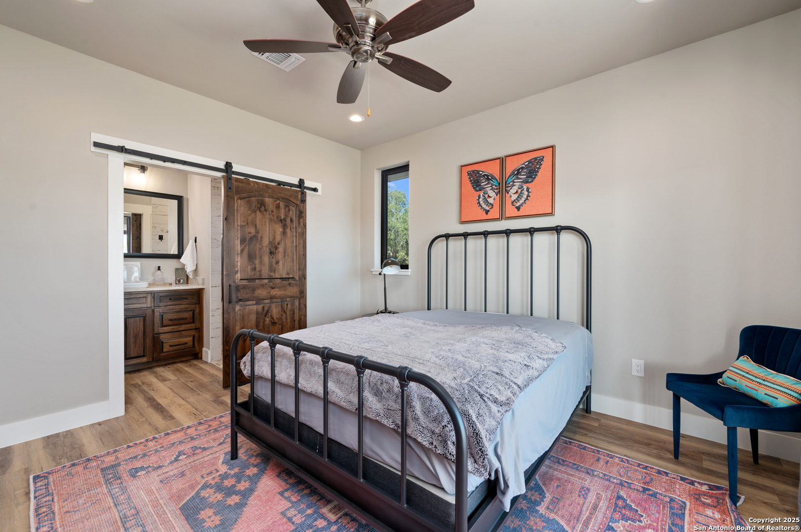 235 Sattler Road Spring Branch, TX 78070 - Photo 34 of 43 a bedroom with a bed and a chandelier